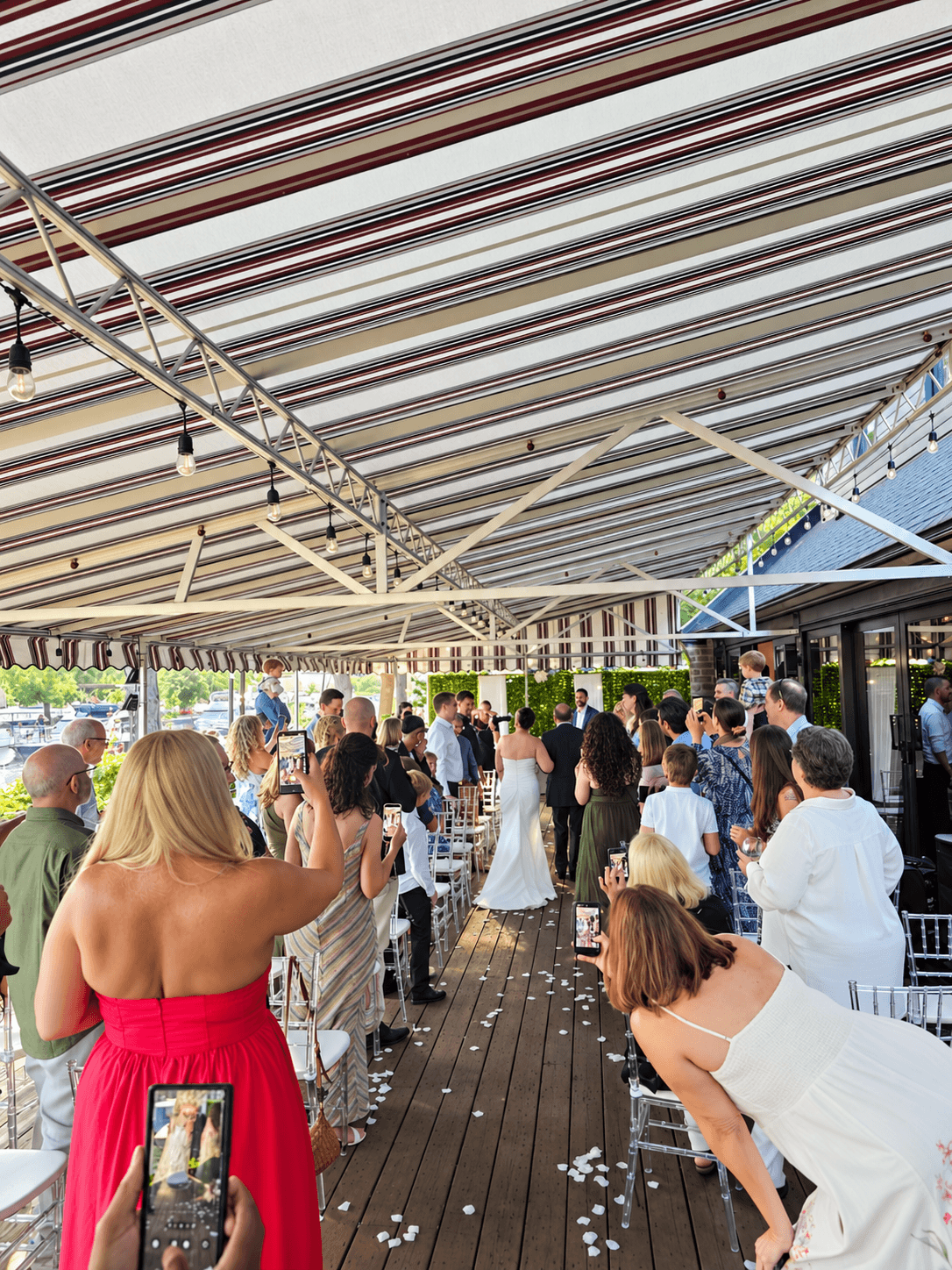 Wedding guests gathered for a waterfront ceremony